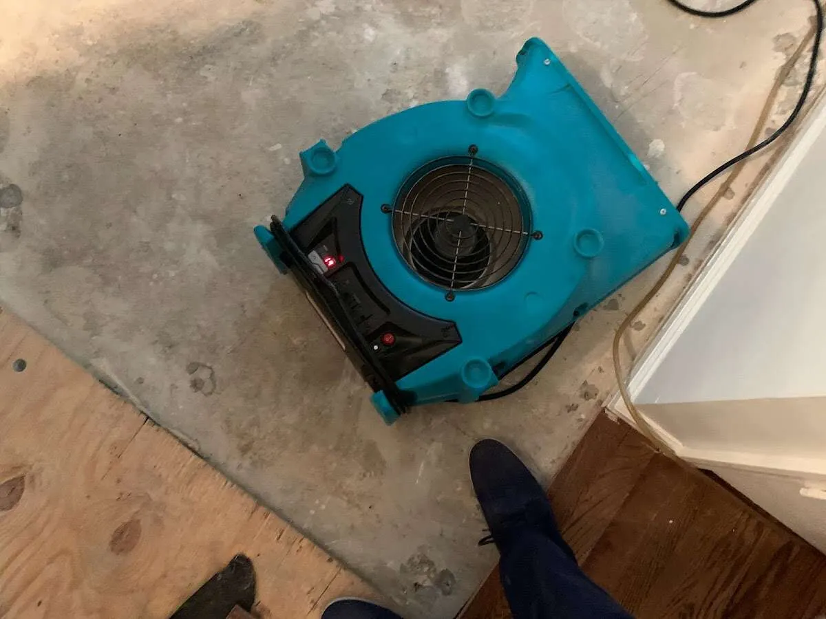 Air mover drying subfloor during Commercial Water Damage Restoration in Severna Park